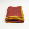 Terracotta Heather cashmere throw blanket with Golden Ochre trim, folded