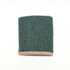 A dark green textured fabric sleeve or cuff with a ribbed light pink trim at the bottom, shown on a plain white background.
