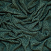 Dark green heathered knit fabric with a textured, ribbed pattern, shown in soft draped folds.