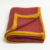 Terracotta Heather cashmere throw blanket with Golden Ochre trim, folded